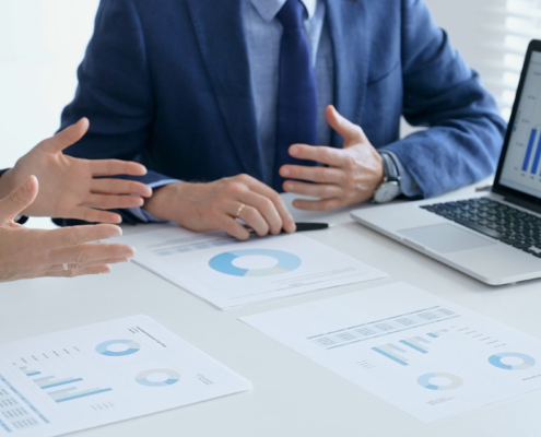 Business,People,Reviewing,Financial,Data,,Discussing,And,Shared,Documents,During